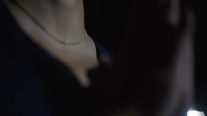 Man with hands clasped and one outer tooth at night