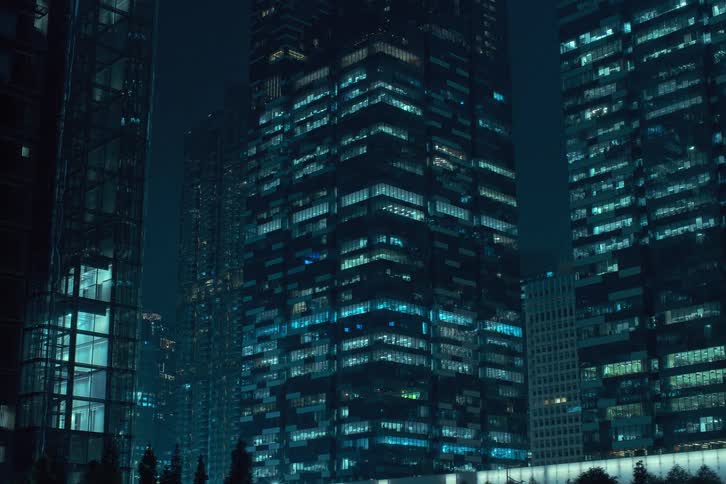 Interior lights of downtown skyscrapers blinking and flickering as the night passes