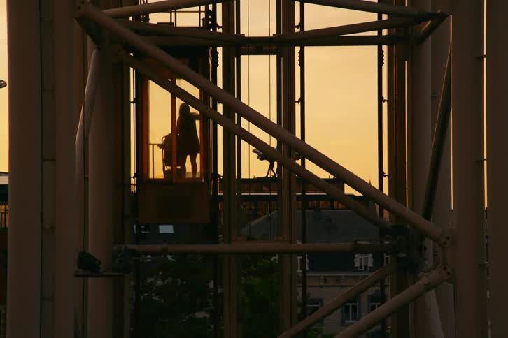 A woman rides up the lift on the tower