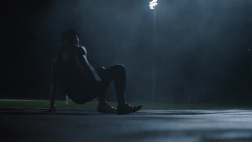 A man lays down on the track at night