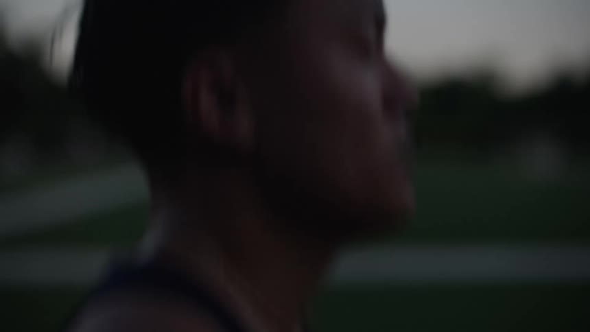 A man is jogging around the track
