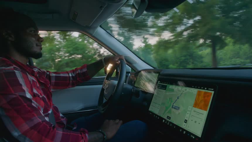 Man driving and interacting with multimedia