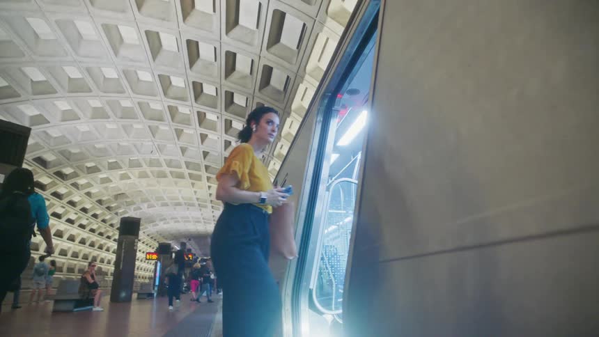 Woman entering a subway at a terminal
