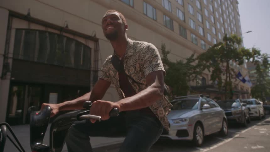 Man on a bicycle pedaling through the streets of a metropolis