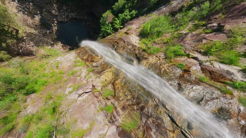 Aerial view of the waterfall pours over the steep cliff
