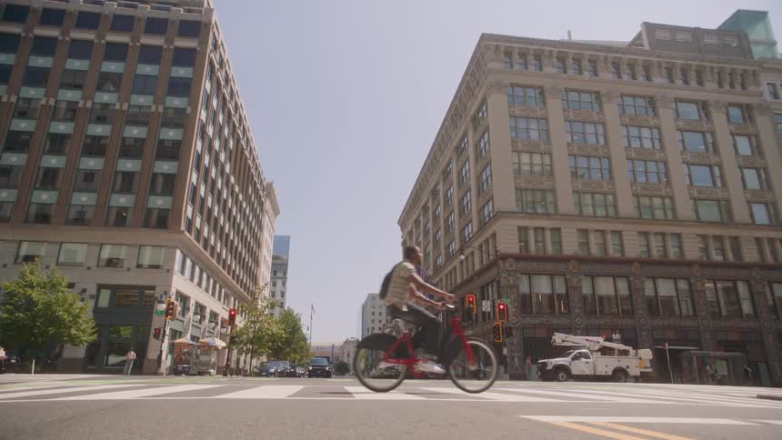 A man is riding his bicycle in the city