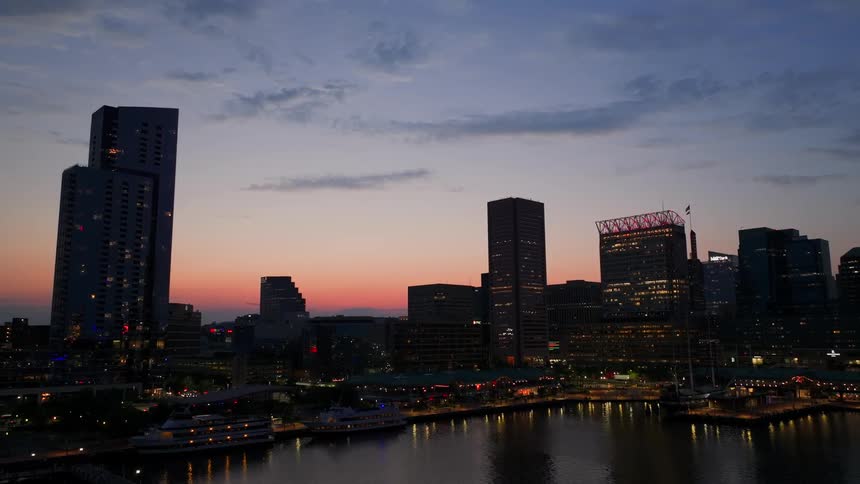 Aerial panorama of a metropolis with modern illuminated buildings on the seafront