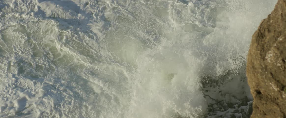Strong ocean water hitting the rocky shore