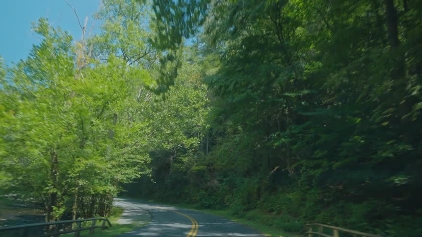 Driving down a paved road around a bend