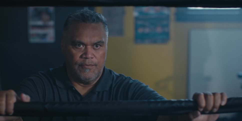 Man talking outside a boxing ring