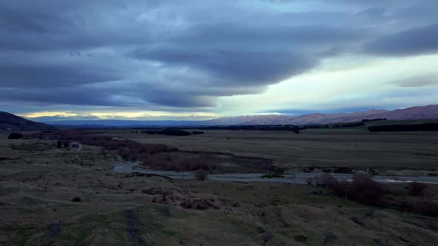 Twilight landscape with dark clouds and a break of lighter sky on the horizon