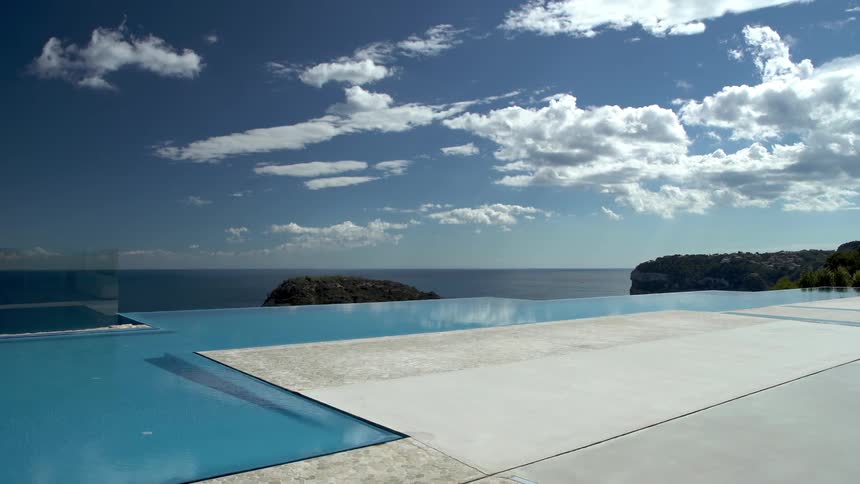 Swimming pool with views of the sky and the coast in the background
