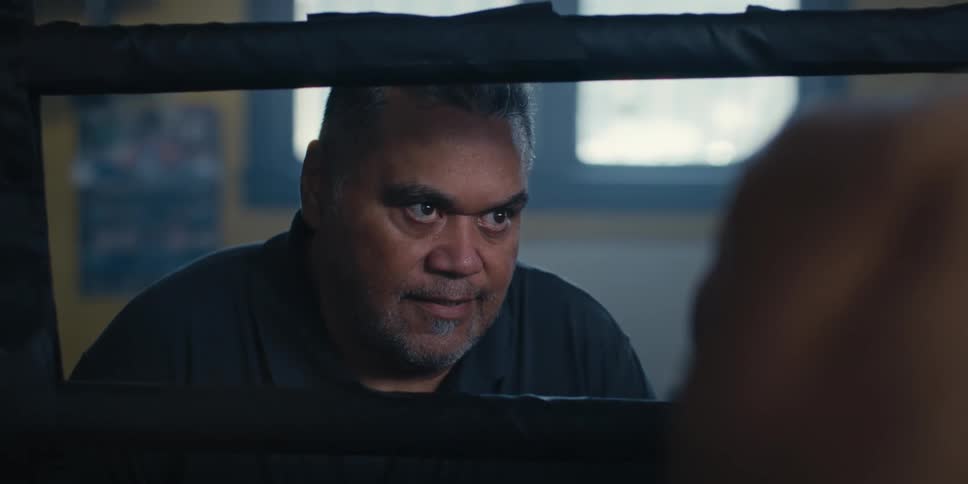 Man talking to another man who is inside a ring