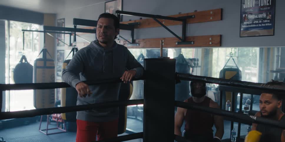 Coach talking to boxers in a gym