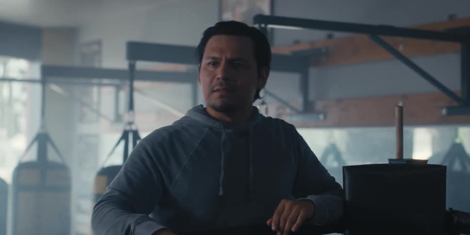 Trainer motivating his fighter who is in a boxing ring and they touch hands
