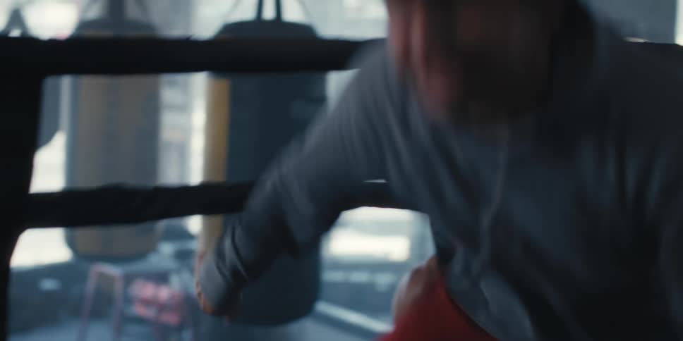 Stressed man entering a ring and other fighters entering behind him