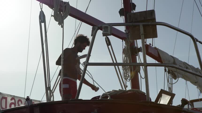 Man arranging ropes on a boat
