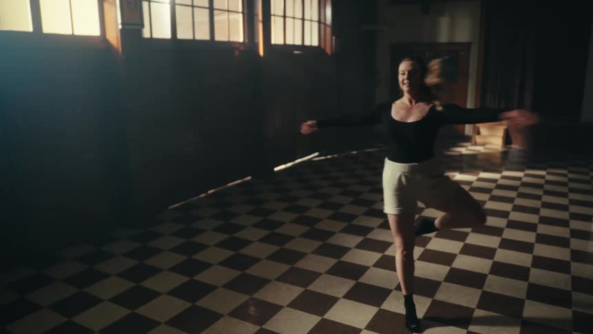 Young woman dancing ballet in a room