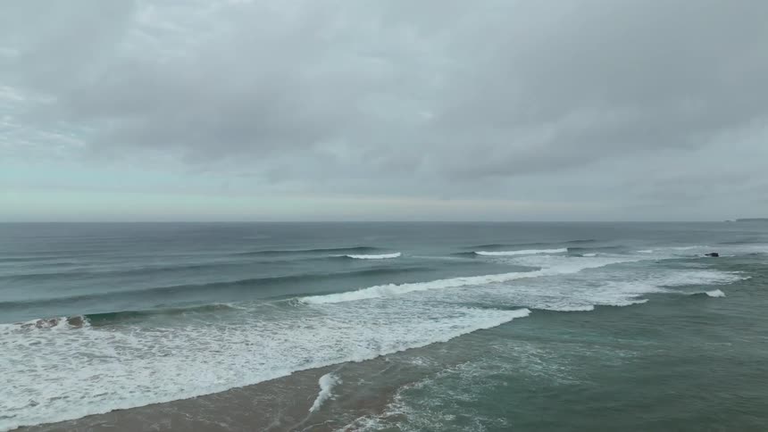 Small waves crash on the shore