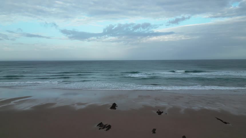 Landscape on a cloudy morning of a long beach
