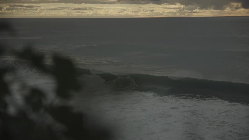 Big and strong wave in the ocean on a cloudy day at dawn