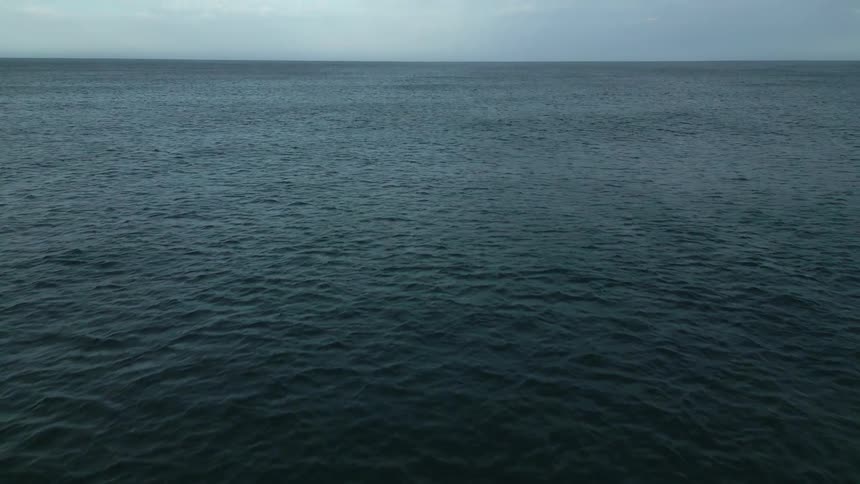Vast expanse of the ocean under an overcast sky