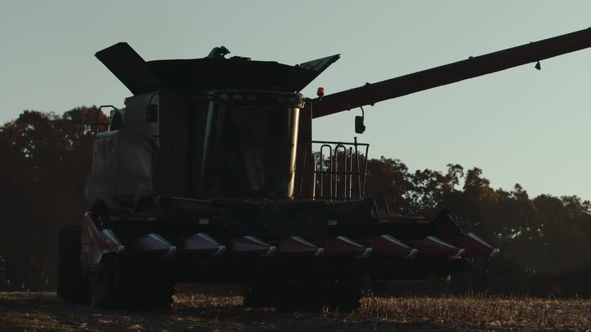 Farming combine rolling through a field