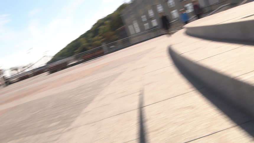 A skateboarder jumps over the steps