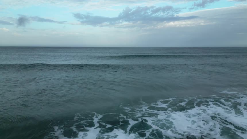 Aerial panoramas of a vast sea with waves on a cloudy morning
