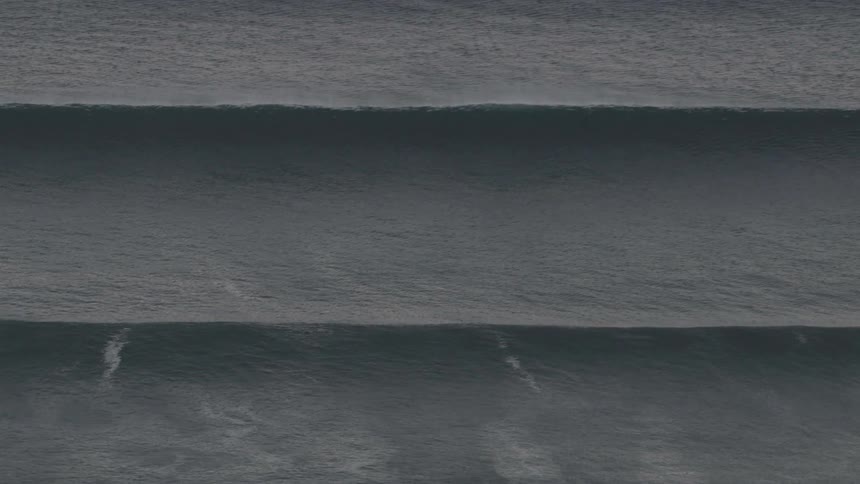 Aerial view of two large waves in an ocean
