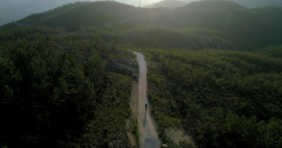 Person running up a hilly road