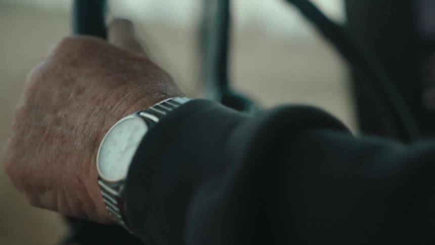 Closeup of a persons hands driving a tractor through a field