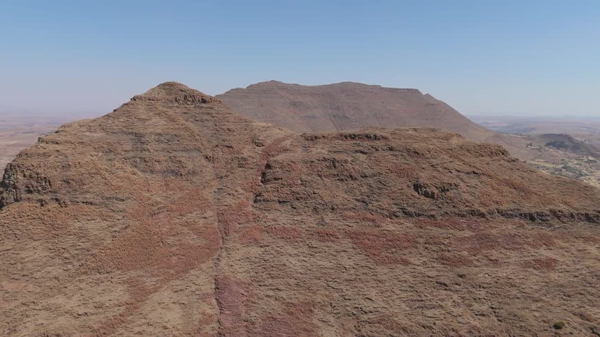 Aerial view of a large flat topped mesa in a desert landscape