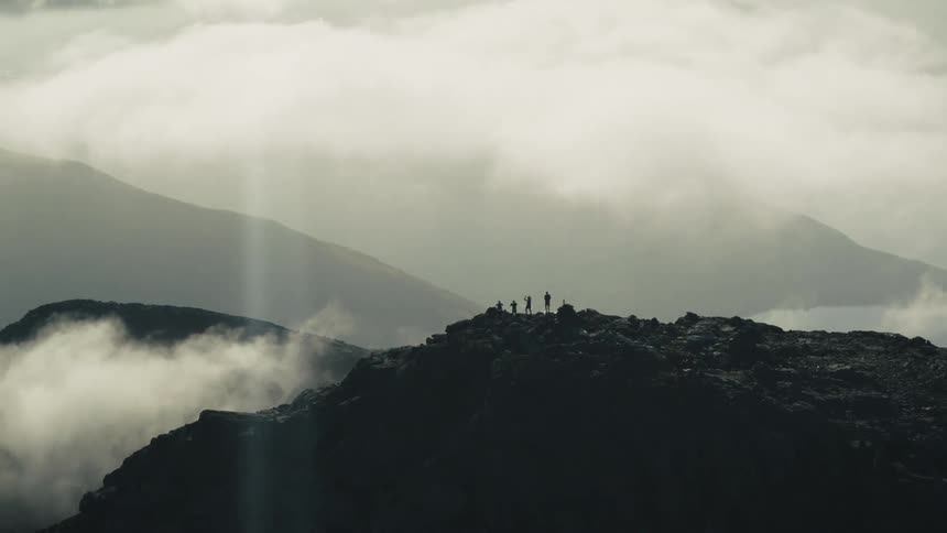 People are hiking on the mountain in the distance