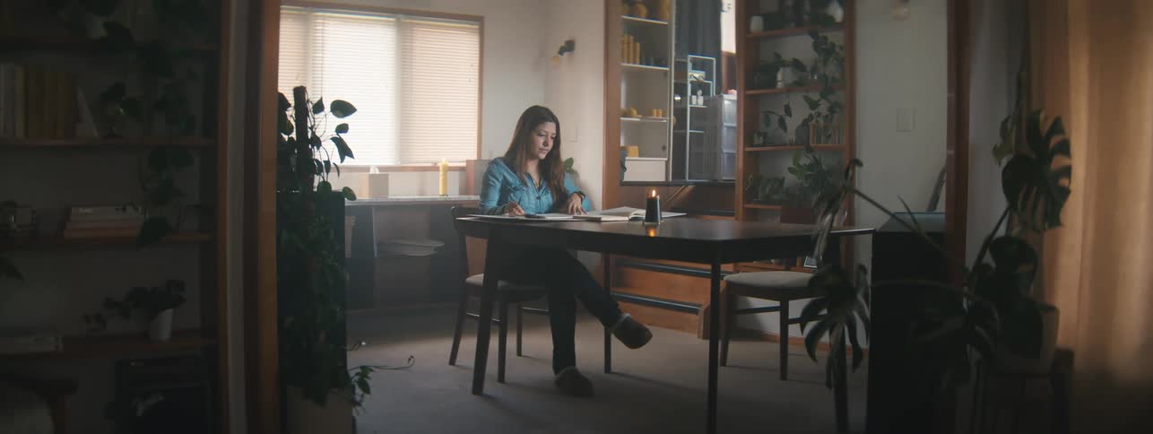 Woman sitting at a table writing
