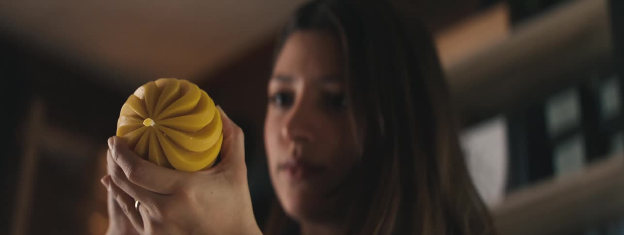 Portrait of a woman with a brush painting a yellow object