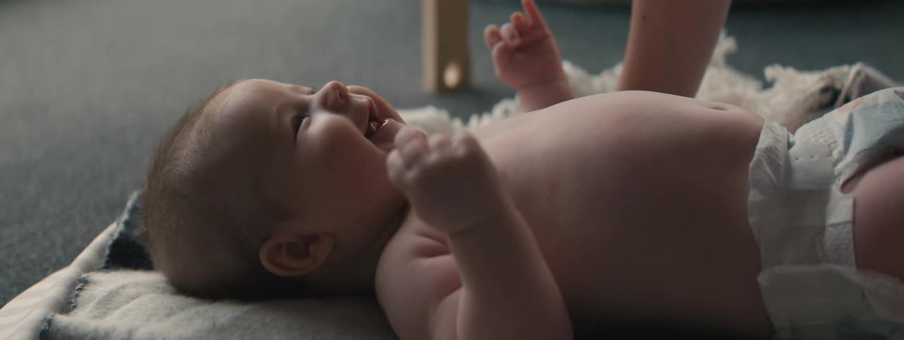 A baby moves around on his back