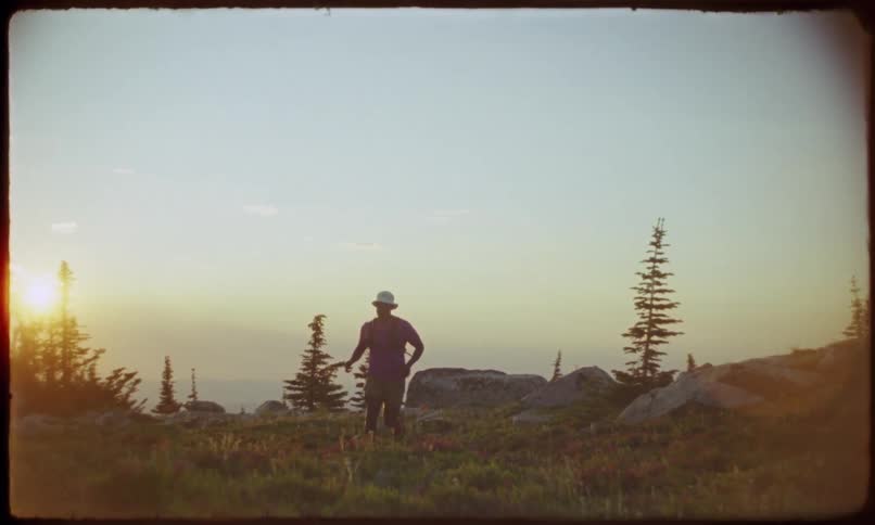 A man is jogging at sunrise