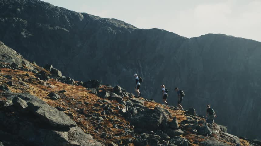 People are hiking up the tall mountain