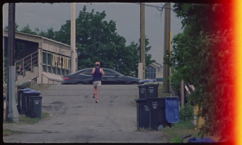 Back view of a person running up a street