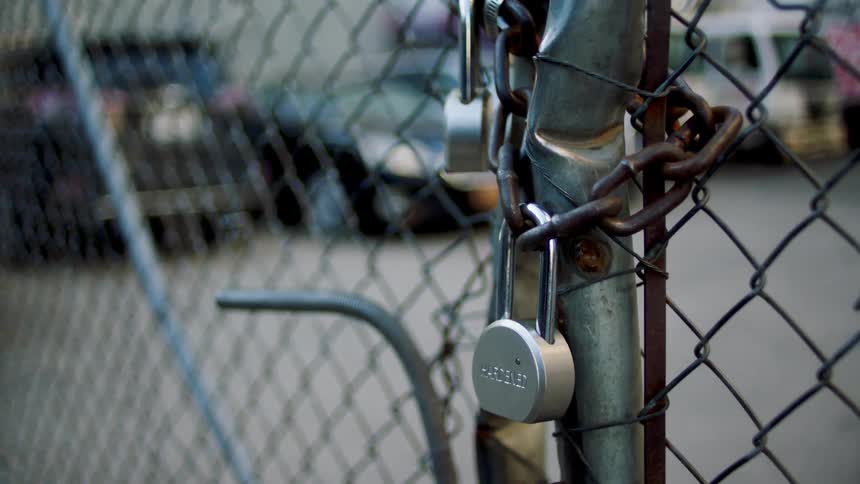 A locked up gate is pushed