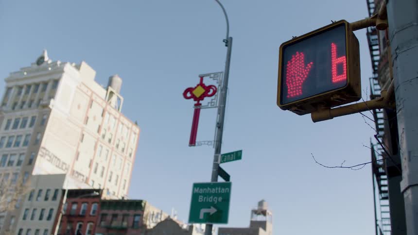 Pedestrian traffic sign displaying a red hand with a countdown timer