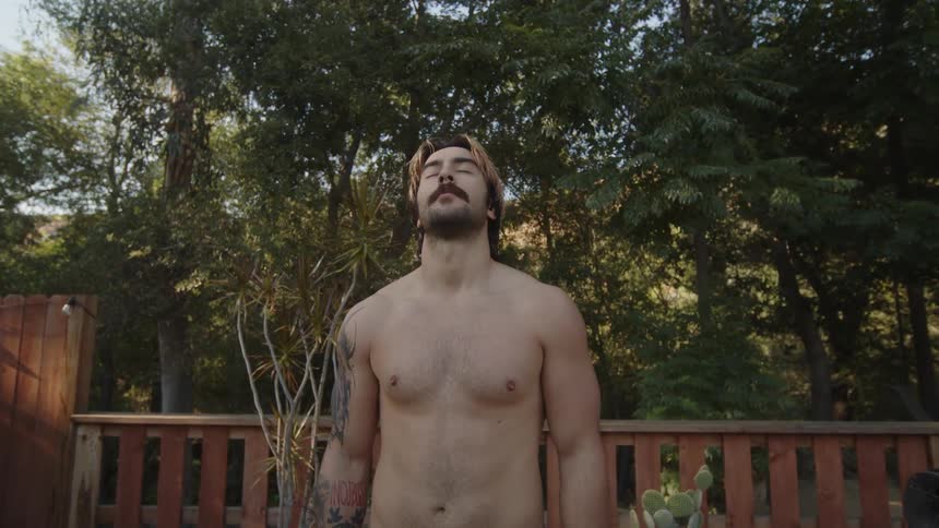 A shirtless man sighs