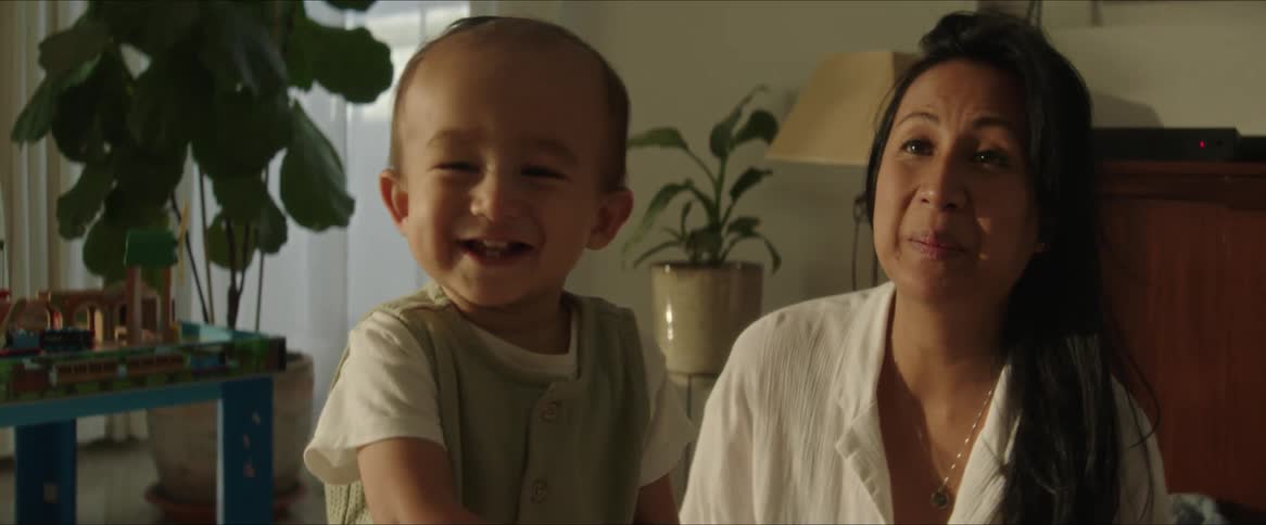 A mom smiles at her baby