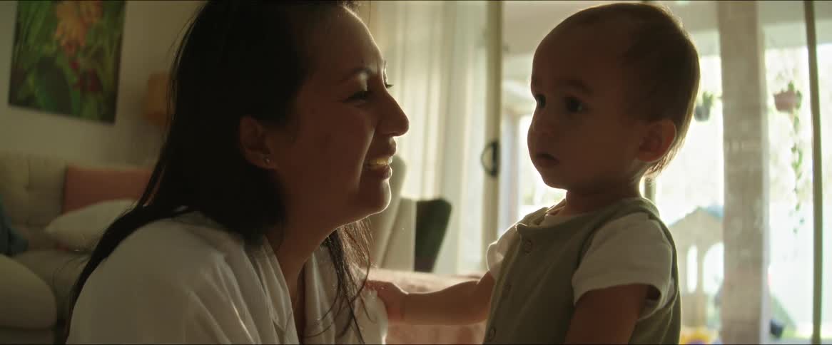 A mom smiles at her baby