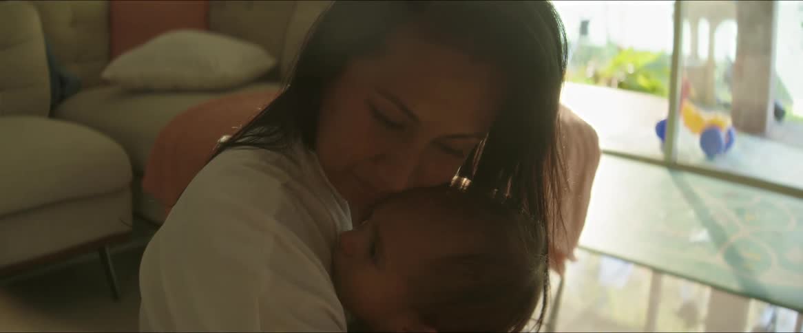 Mother lovingly hugging her baby