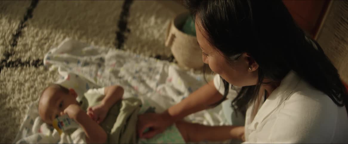 A mom changes her babys diaper