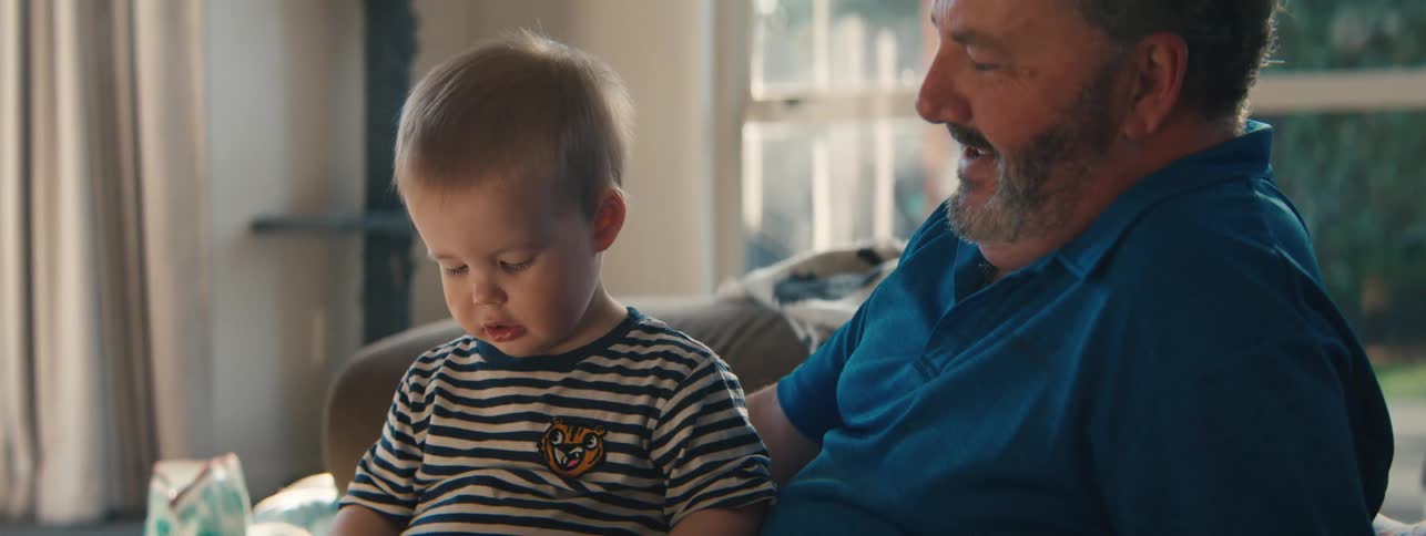 Child playing while sitting on fathers lap