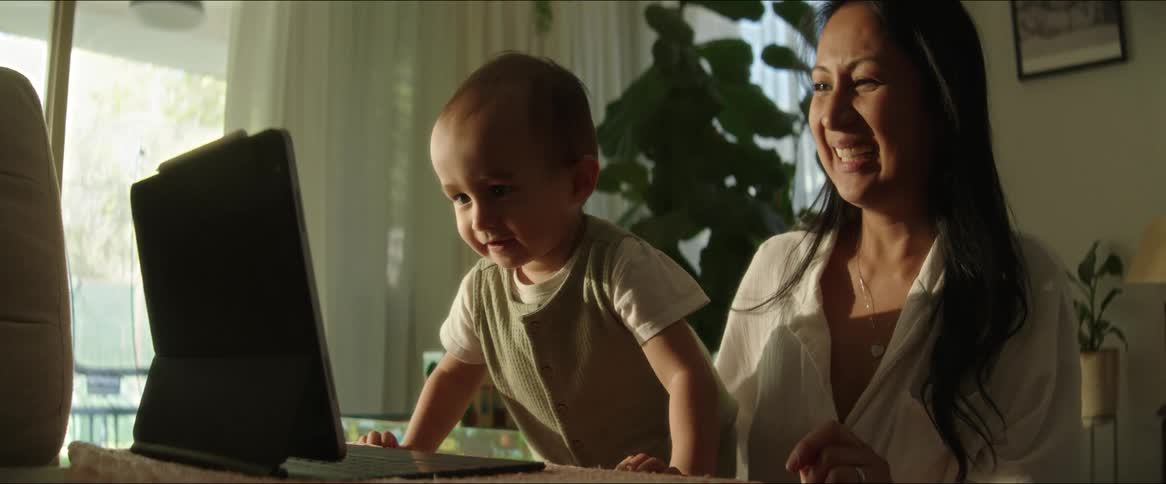 Mother with her baby in front of a laptop