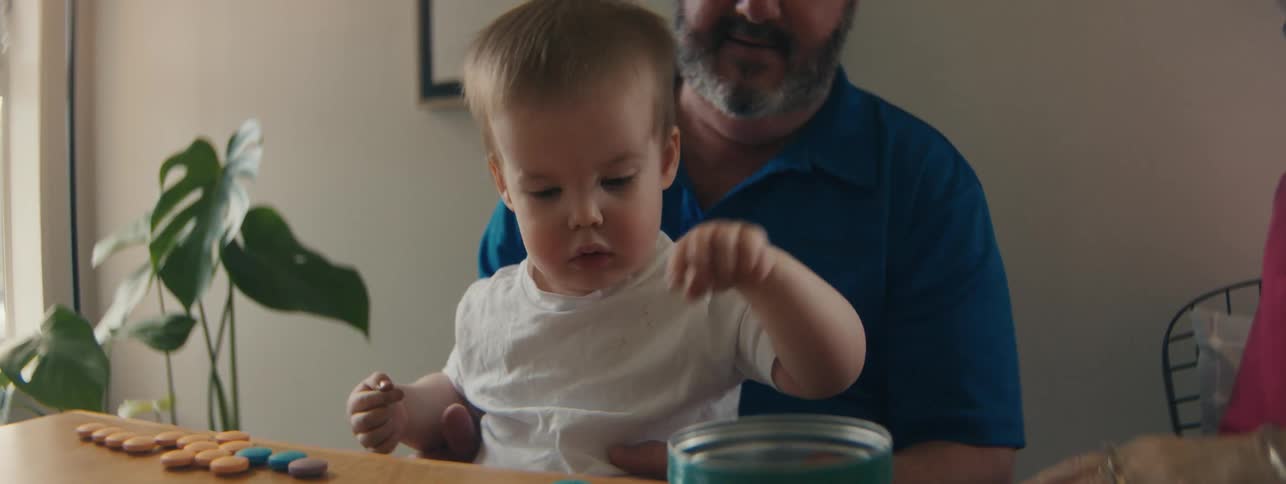 Little child sitting at table playing